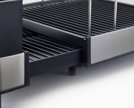 Joseph Joseph Extend Max stainless steel expandable dish rack loaded with dishes beside a sink, Homelux Kenya