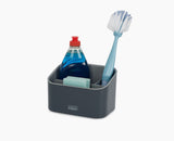 Joseph Joseph SinkStore tiered sink tidy in grey, closed and standing beside a sink.