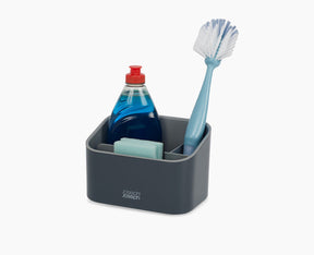 Joseph Joseph SinkStore tiered sink tidy in grey, closed and standing beside a sink.