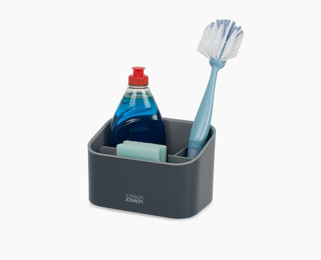 Joseph Joseph SinkStore tiered sink tidy in grey, closed and standing beside a sink.