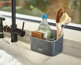 The caddy open, showing a washing-up liquid bottle, dish brush and sponges in their sections.