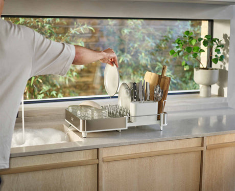 Joseph Joseph Extend Steel dish rack movable draining spout directing water into the sink