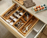 Overhead view of the five overlapping cutlery compartments with their identification icons.