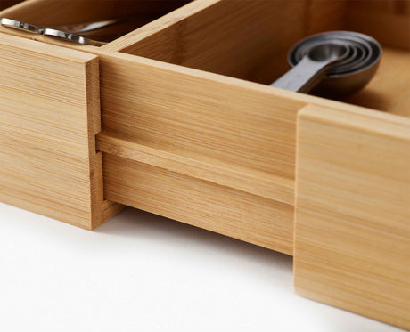 The organiser sitting in an open kitchen drawer with cutlery and utensils in place.