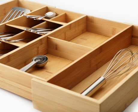 The two deep-sided gadget compartments holding a tin opener and peeler.
