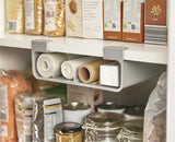 The grey organiser fixed beneath a cupboard shelf holding rolls of cling film and foil.