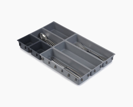 Joseph Joseph Blox 7-piece drawer organiser set in grey, clipped together as one unit.