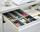 The seven trays laid out separately to show the different sizes in the set.