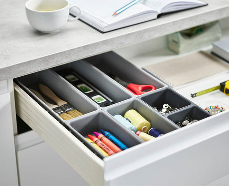 The seven trays laid out separately to show the different sizes in the set.