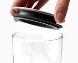 Pouring from a round-profile glass container to show the clean pour edge.