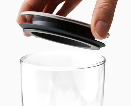 Pouring from a round-profile glass container to show the clean pour edge.