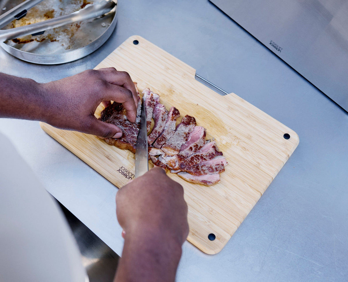 Joseph Joseph Nest Boards Bamboo 3 piece chopping board set with stand board in use on a kitchen counter, Homelux Kenya