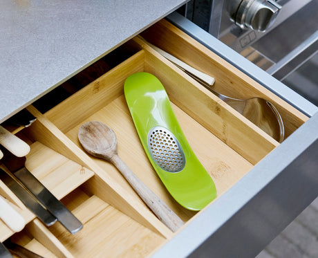 The Rocker garlic crusher photographed in a kitchen setting.