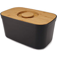 Joseph Joseph melamine bread bin 35 cm in black with beech wood lid, shown closed.