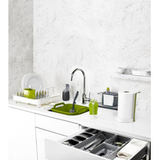 Further product view of the green Joseph Joseph Brush-Up in-sink washing-up brush.