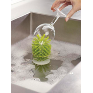 The suction-mounted Joseph Joseph Brush-Up brush, made for washing glasses.