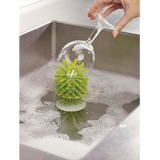 The suction-mounted Joseph Joseph Brush-Up brush, made for washing glasses.