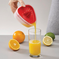 Reversible lid of the red Joseph Joseph Duo citrus juicer, second product image
