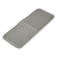 Joseph Joseph Duo foldable draining mat in grey, laid out flat.