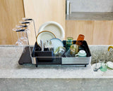 Joseph Joseph Extend Steel Plus dish rack wine glass rail in use