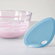 Blue Joseph Joseph Fin curved silicone bowl scraper, second product view.