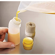 Joseph Joseph Glaze silicone pastry brush in Stone with its two interchangeable heads, third product view.