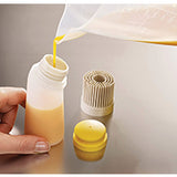 Joseph Joseph Glaze silicone pastry brush in Stone with its two interchangeable heads, third product view.