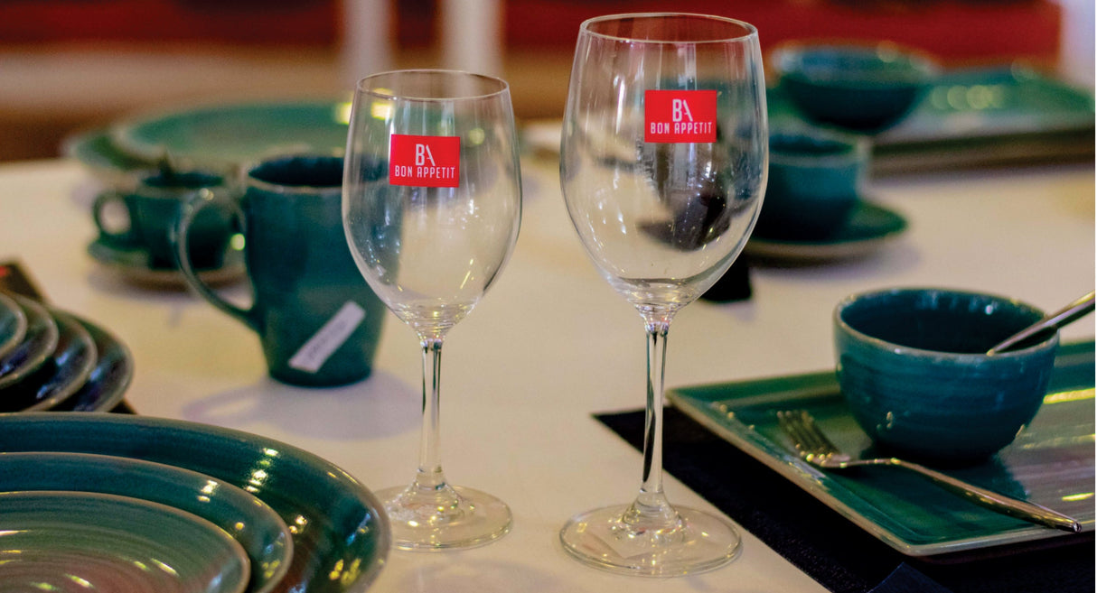 Bon Appetit crystal cold cut fine rim wine stemglasses on a laid table with teal dinnerware