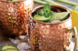 Moscow Mule cocktail with mint, lime and cucumber served in a Bon Appetit copper mug