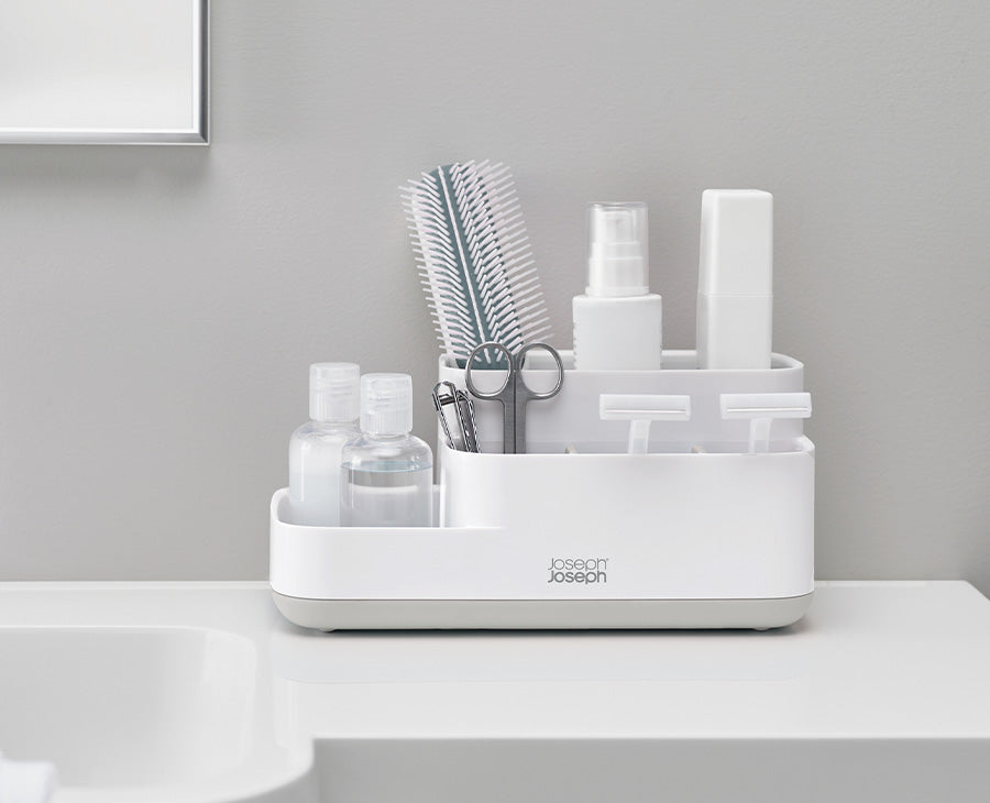 Joseph Joseph EasyStore bathroom caddy compartments filled with toothbrushes and grooming essentials