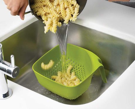 The green square colander viewed from above showing the large vertical draining holes