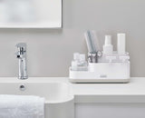 Joseph Joseph EasyStore light grey bathroom caddy on a bathroom countertop
