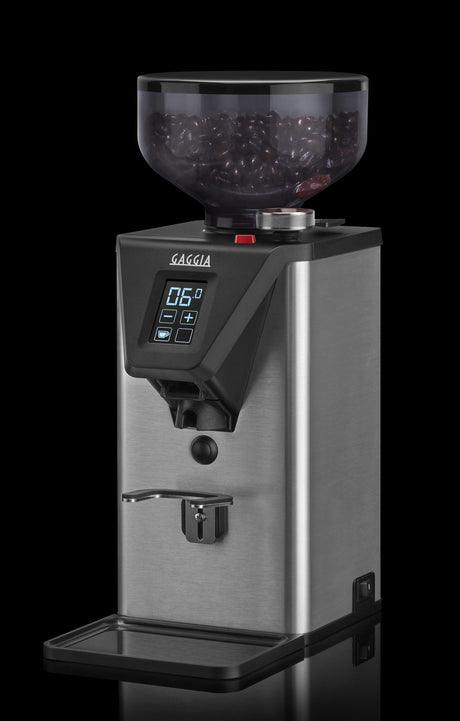 Gaggia MDF 55 coffee grinder angled view with ground coffee, dark background