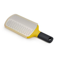 Joseph Joseph Multi-Grate paddle grater in yellow with coarse and fine blades and a sheath.