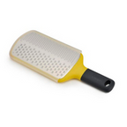 Joseph Joseph Multi-Grate paddle grater in yellow with coarse and fine blades and a sheath.