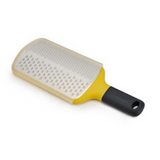 Joseph Joseph Multi-Grate paddle grater in yellow with coarse and fine blades and a sheath.