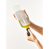 Yellow Joseph Joseph Multi-Grate paddle grater with its sheath, second product view.