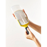 Yellow Joseph Joseph Multi-Grate paddle grater with its sheath, second product view.