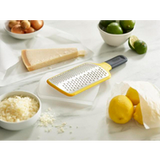 Joseph Joseph Multi-Grate paddle grater in yellow with coarse and fine blades, fifth product view.