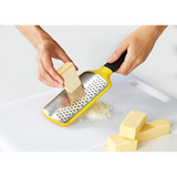 Joseph Joseph Multi-Grate paddle grater showing its coarse and fine blades, third product view.