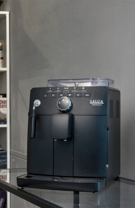 Gaggia Naviglio Black coffee machine in a kitchen setting brewing espresso