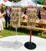 Pink bow champagne flutes at a garden party, clear stem and red stem