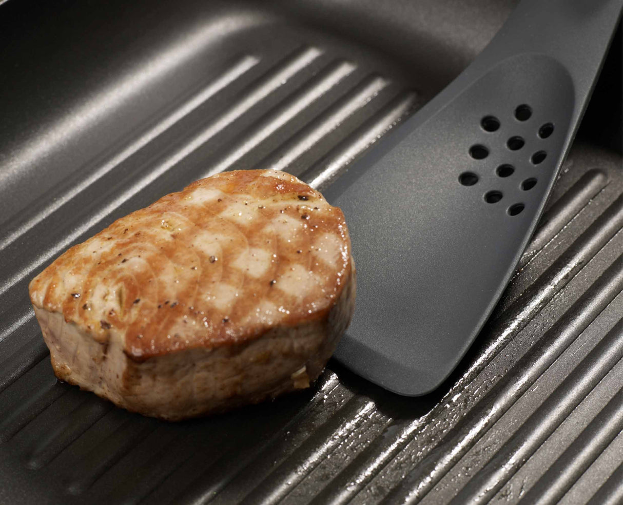 The shaped cutting edge slicing through a piece of food to test it.