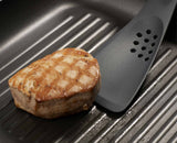 The shaped cutting edge slicing through a piece of food to test it.