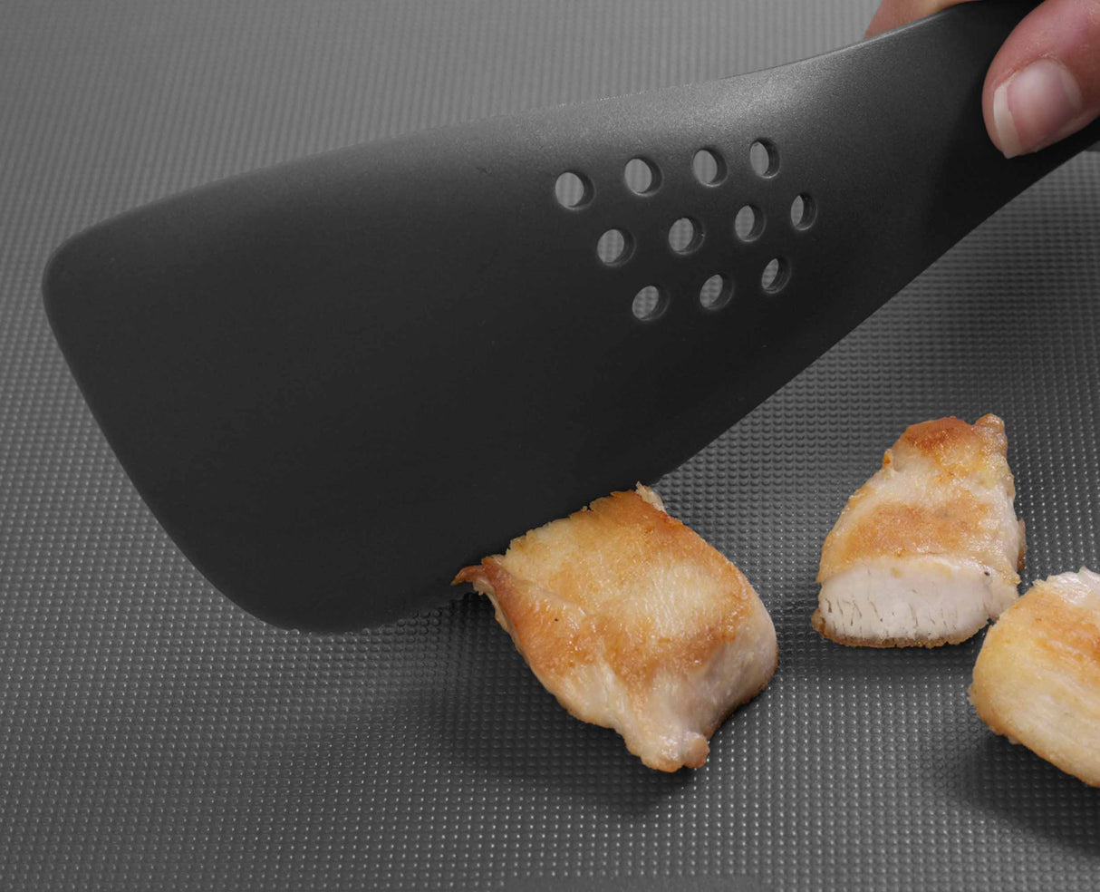 The utensil serving food from a pan onto a plate.