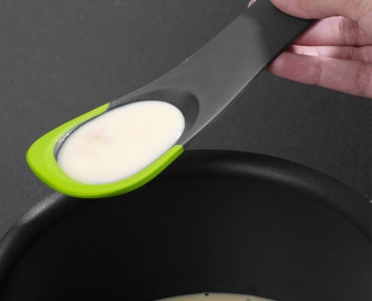 The flexible edge scraping the last of a sauce from the side of a pan.