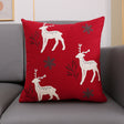 Christmas cushion cover 45x45cm, red canvas with three embroidered reindeer and snowflakes on a grey sofa