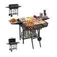 Double sided dual use charcoal BBQ grill with side shelves loaded with skewers and meat
