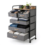 5 drawer fabric storage tower with folded clothes in the large drawers and accessories in the small drawers