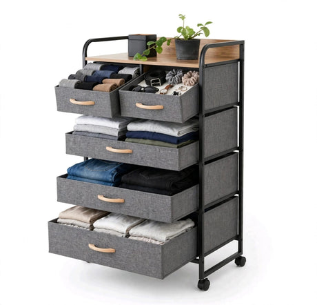 5 drawer fabric storage tower with folded clothes in the large drawers and accessories in the small drawers